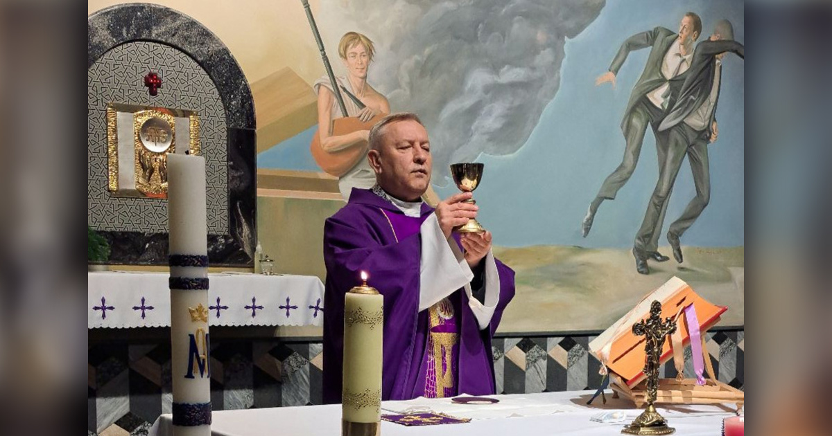 The priest Anatol Parakhnevich is raising a communion cup. The priest Anatol Parakhnevich is raising a communion cup.