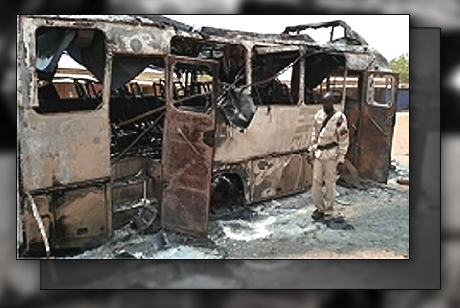 Man standing by burned out bus. - Photo: VOM Poland