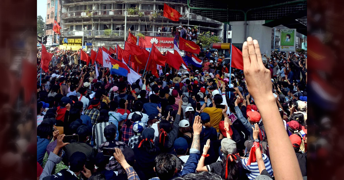 Crowd holding flags and raising the 