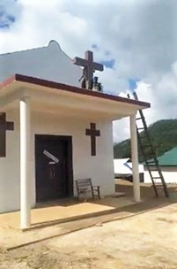 A United Wa State Army (UWSA) militant toppling a cross on a church building. - Photo: Facebook via Morning Star News