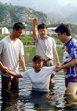 Pastor Cai performing a baptism