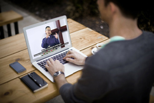 Man watching online sermon - Photo: Derivative from Early Rain Covenant Church