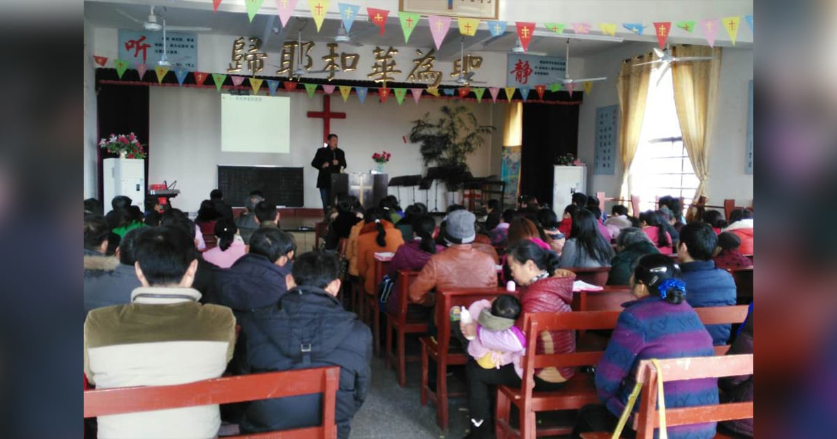 Believers are sitting on benches as they listen to God's Word. Believers are sitting on benches as they listen to God's Word.