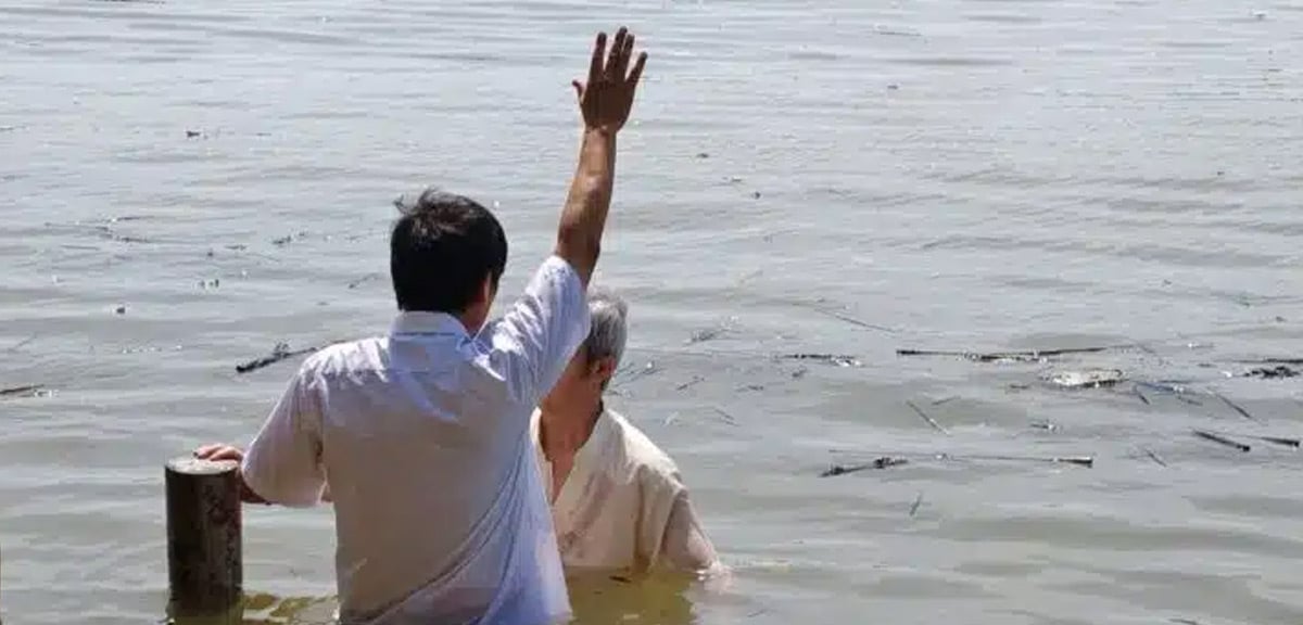 John Cao is baptizing a believer.