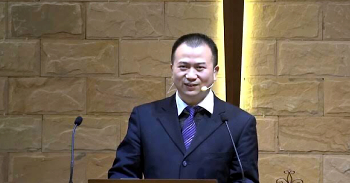 Li Yingqiang is standing at a pulpit.