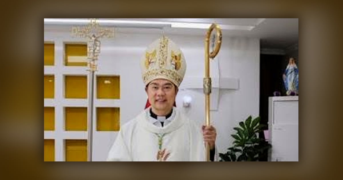 A priest is holding a staff and has a headpiece on.