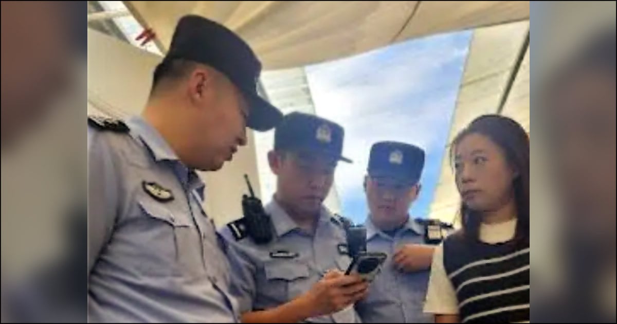 Three police officers are browsing through a phone as a church member looks on.