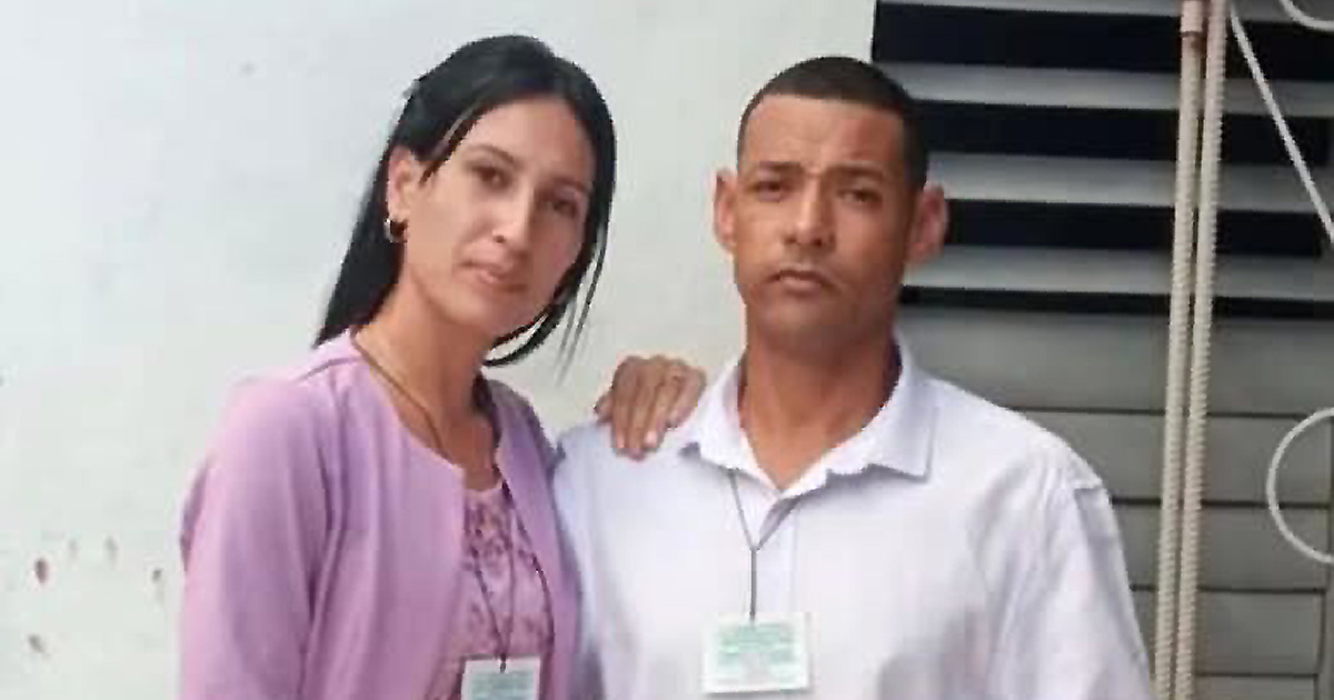 Photograph shows Pastor Velázquez and his wife. She is in a purple blouse and he is wearing a white collared shirt. &nbsp;They are standing side by side with identification badges.