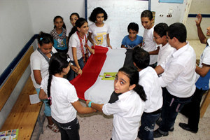 Egyptian Christian children gather round the country’s flag in a group activity. -- Photo: World Watch Monitor