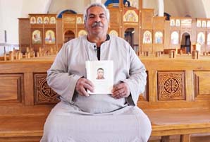 Father with a picture of his son who was beheaded