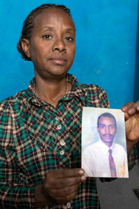 Eritrean Christian, Mulu, holding a picture of her husband. - Photo: VOM US www.icommittopray.com