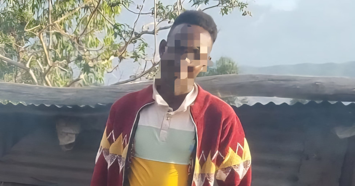 Ibrahim Mohammed's face is pixelated to obscure his identity. He is standing in front of his home.