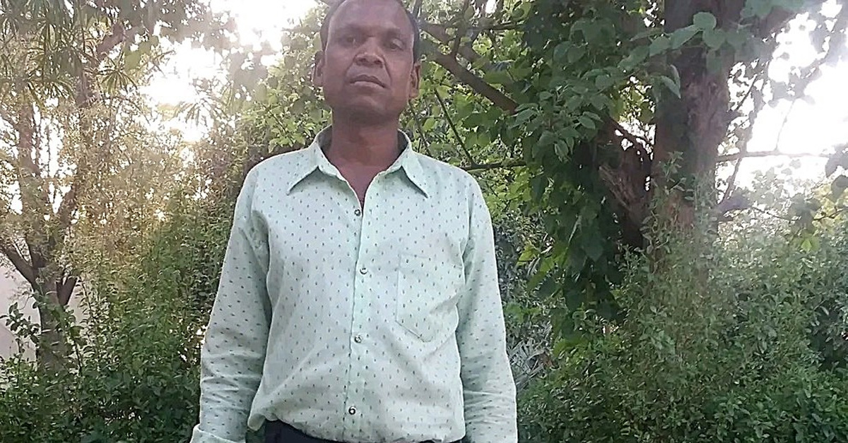 Chhot Singh Dhurve, one of the imprisoned pastors, stands on a path in front of foliage. Chhot Singh Dhurve, one of the imprisoned pastors, stands on a path in front of foliage.