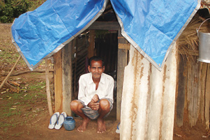 A man sitting at the door of his tent in a refugee camp in 2009.