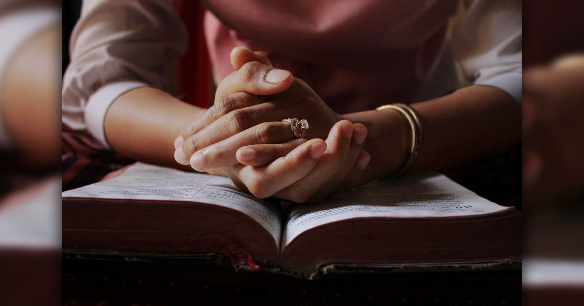 Woman's hands folded in prayer