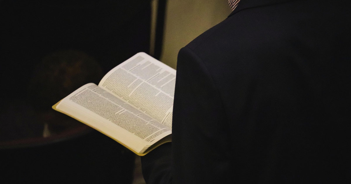 A man reading a Bible.