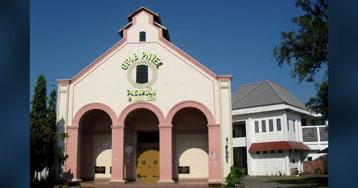A church is brightly illuminated in the sun.