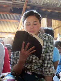 A Laotian believer reading her Bible - Photo: VOM USA www.icommittopray.com