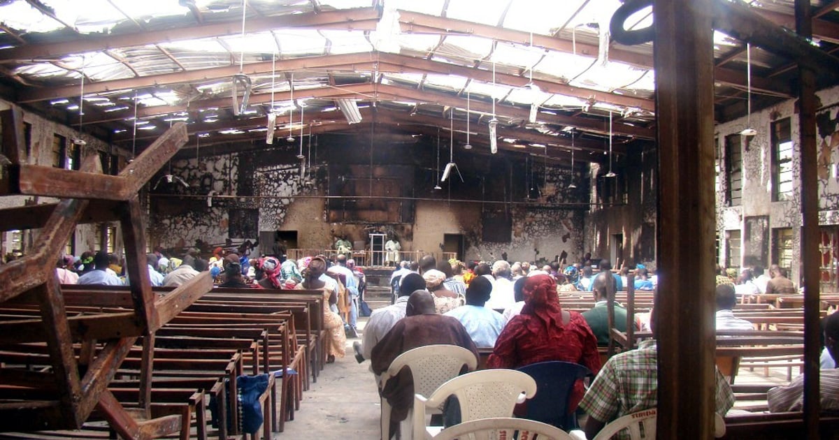 Believers are gathered in the shell of a burned out church.