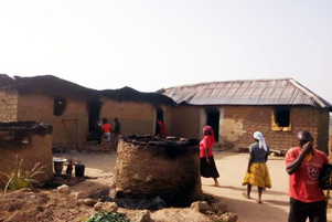 Christians survey the damage from a Fulani attack. - Photo: Release International www.releaseinternational.org