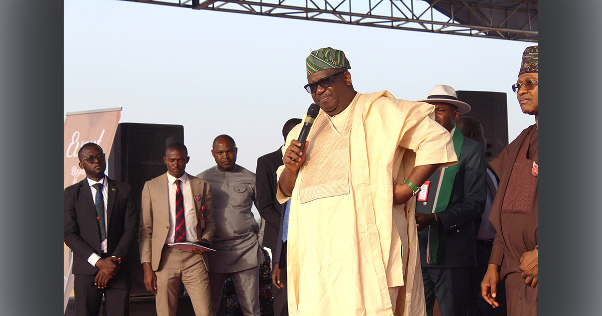 Governor Caleb Manasseh Mutfwang is speaking with a microphone. He is surrounded by other men on stage. Governor Caleb Manasseh Mutfwang is speaking with a microphone. He is surrounded by other men on stage.