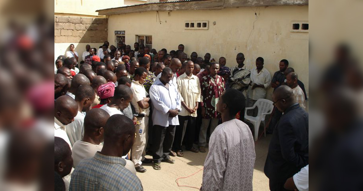 Believers gathered together in prayer.