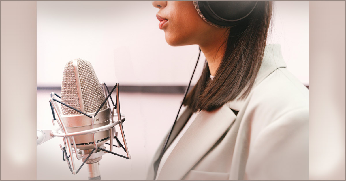 A woman is facing a microphone.