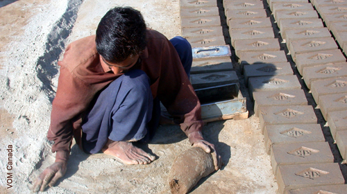 A man is making bricks by hand.