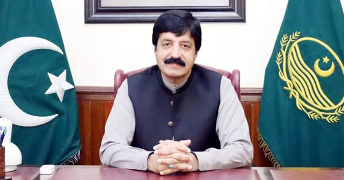 Governor Sardar Saleem Haider Khan is sitting at a desk.