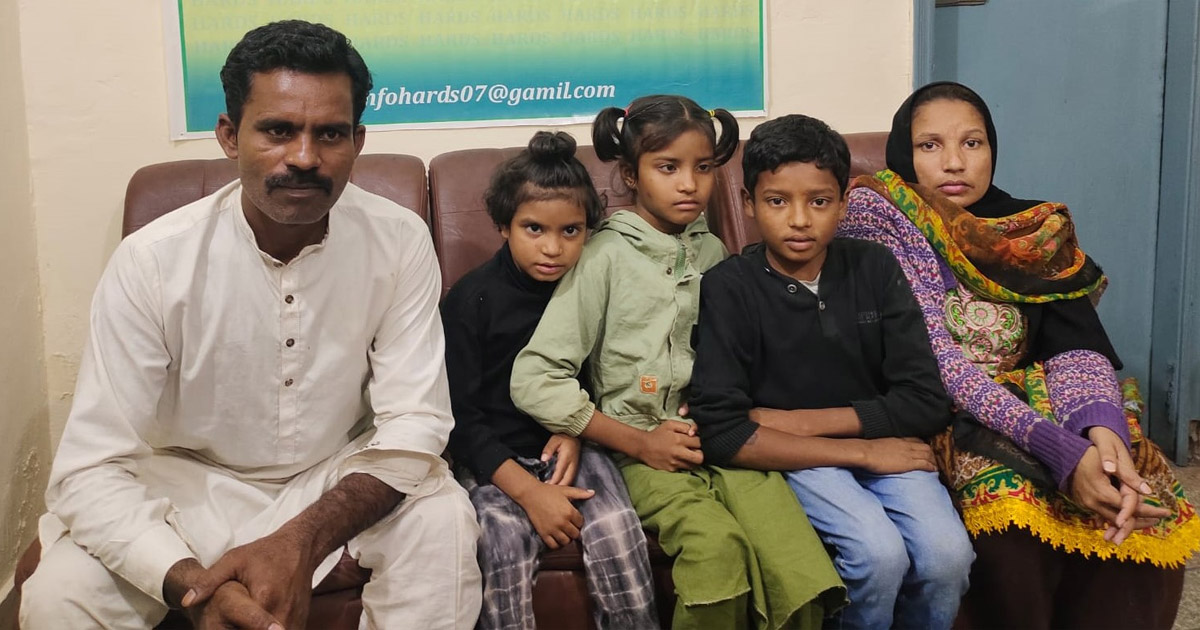 Shaukat,  Kiran, and their children are sitting together.