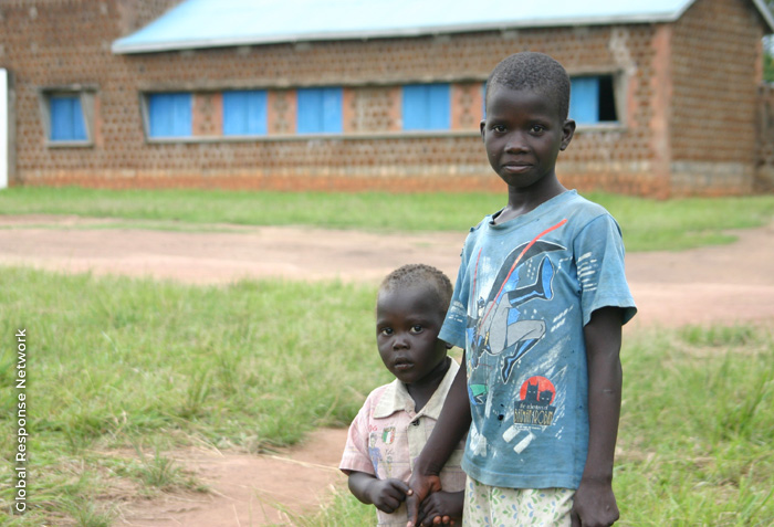 Two boys are holding hands.