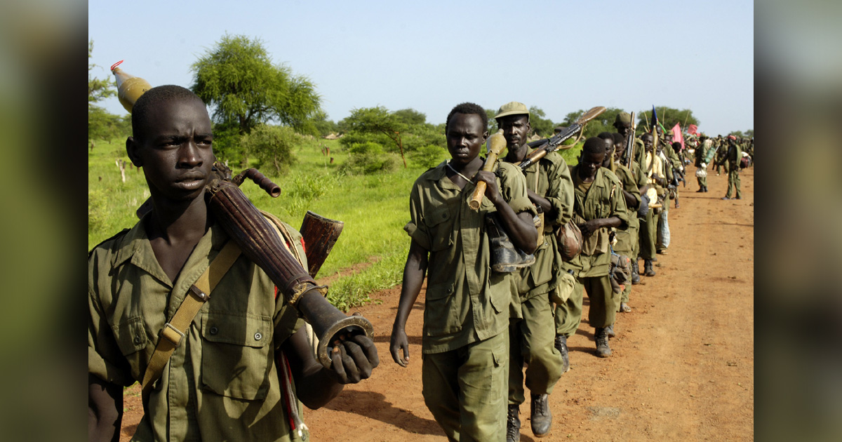 Soldiers are walking down a dirt road. Soldiers are walking down a dirt road.
