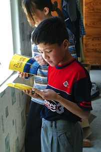 Children in Tajikistan read Gospel books.