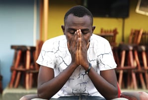 Ugandan man praying