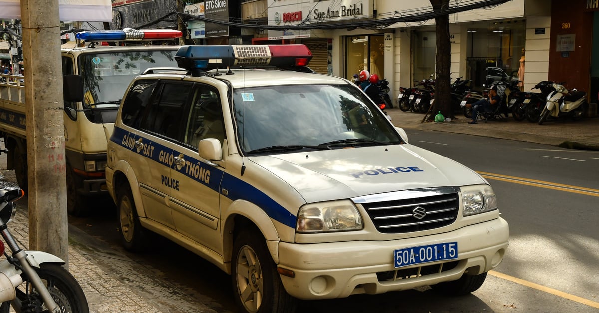 Two police vehicles are parked along a curb.