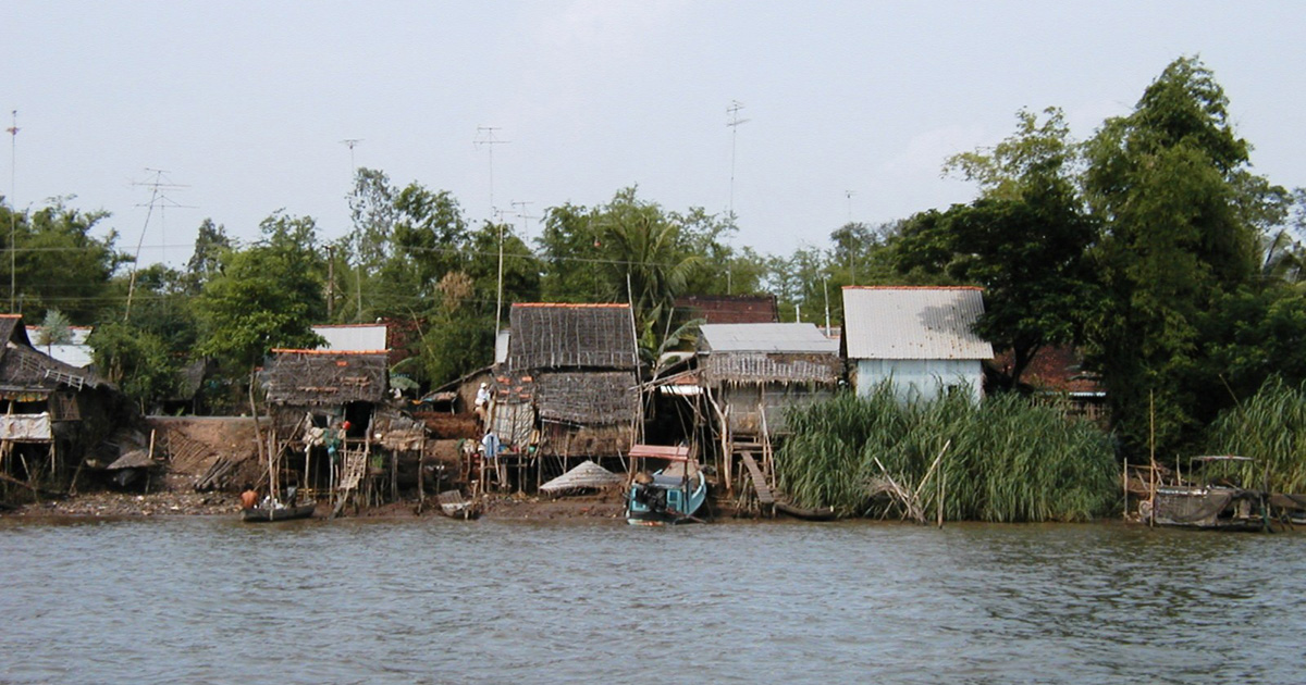 Several houses sit over or near a body of water.