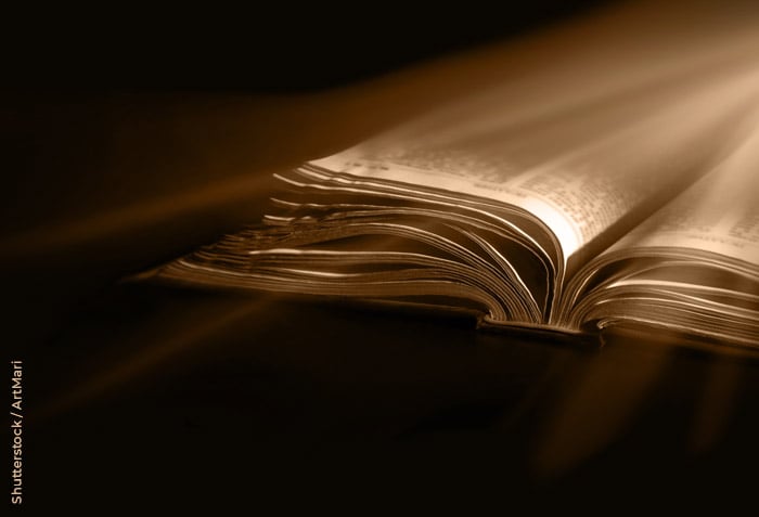 A brilliant light is shining on an open Bible.