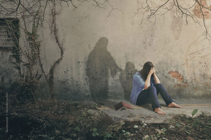 Woman weeping, shadow of Jesus with His hand on her shoulder