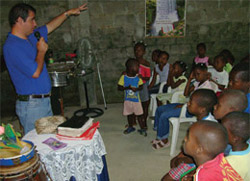 A man is teaching a class of children.