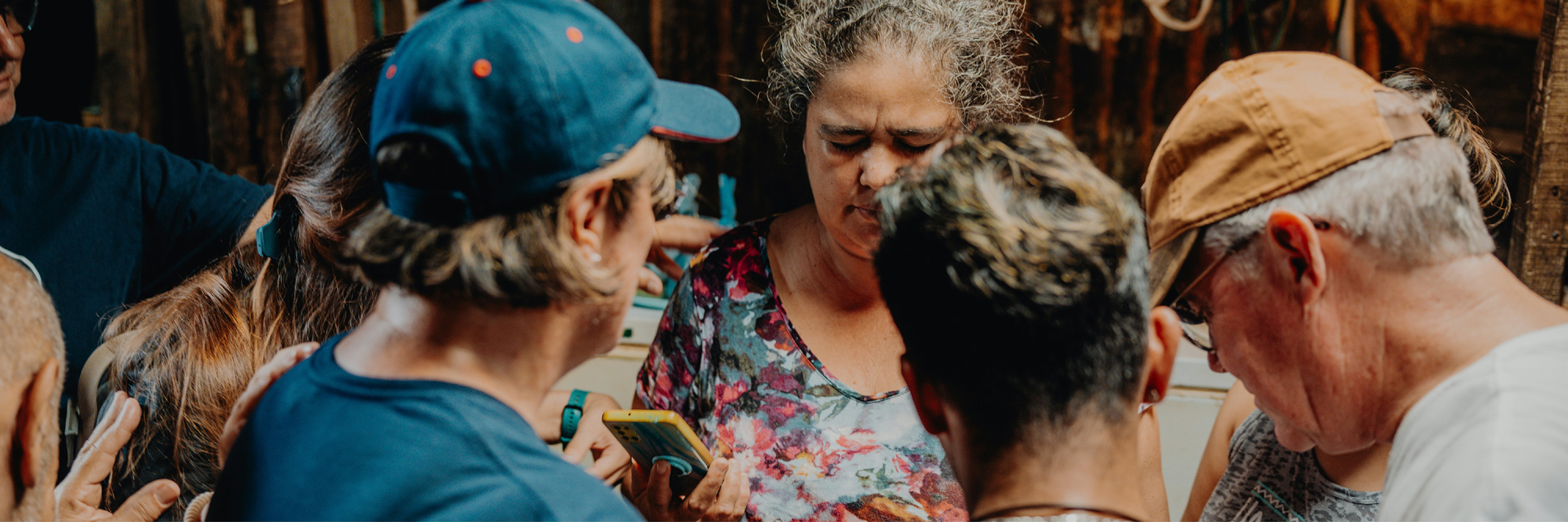 A small group of people is praying together.
