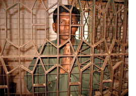 A man looking through prison bars