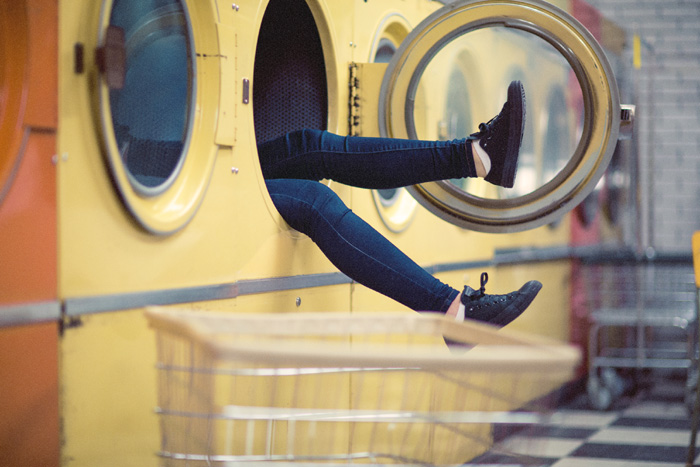 Feet sticking out of a commercial washer