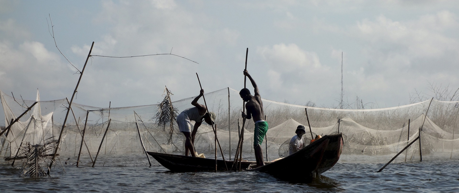 Benin - Men are standing or sitting in boats - Photo: Noemie_gi